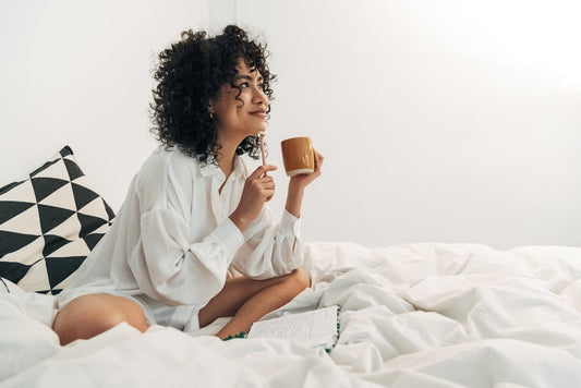 girl chilling in bed with a journal